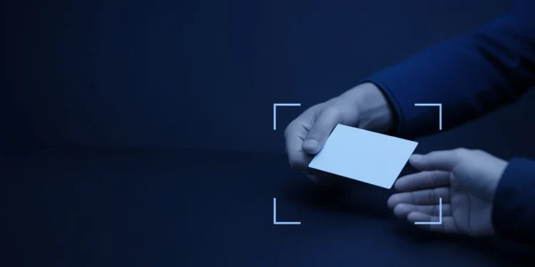 Illustration: two hands passing a blank card across a desk, for the micro1 referral program