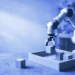 A small robot arm placing a wooden cube into a tray, for a beginner guide to AI agent evaluation jobs