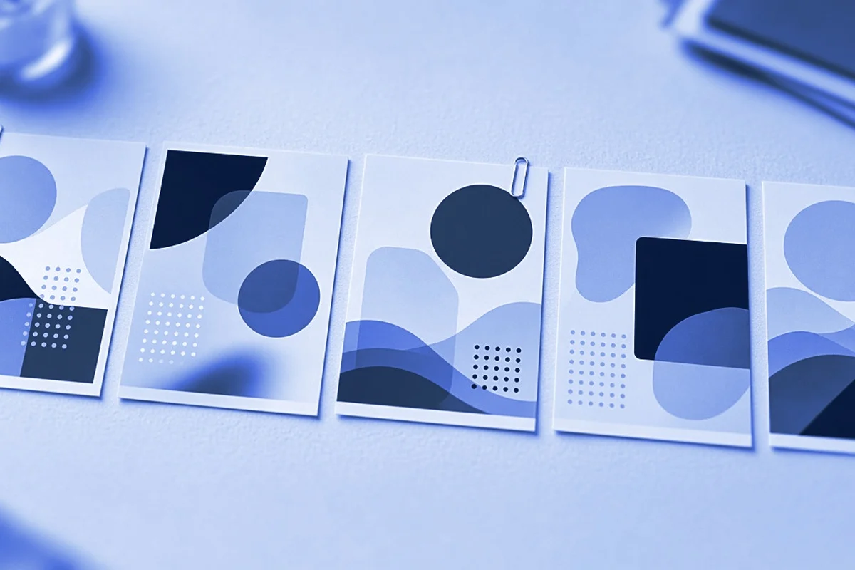 Printed presentation slides laid in a row on a meeting table, two of them marked with paper clips, for AI presentation evaluation jobs