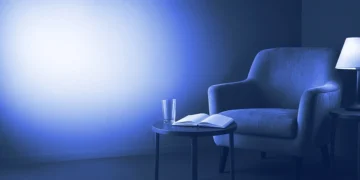 An empty armchair beside a table with a glass and blank notebook, for AI trainer interview questions practice