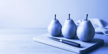Three pears lined up on a board for comparison, for how to rank AI responses with a rubric