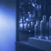 Three unlabelled bottles in a shop window display, for marketing AI trainer jobs